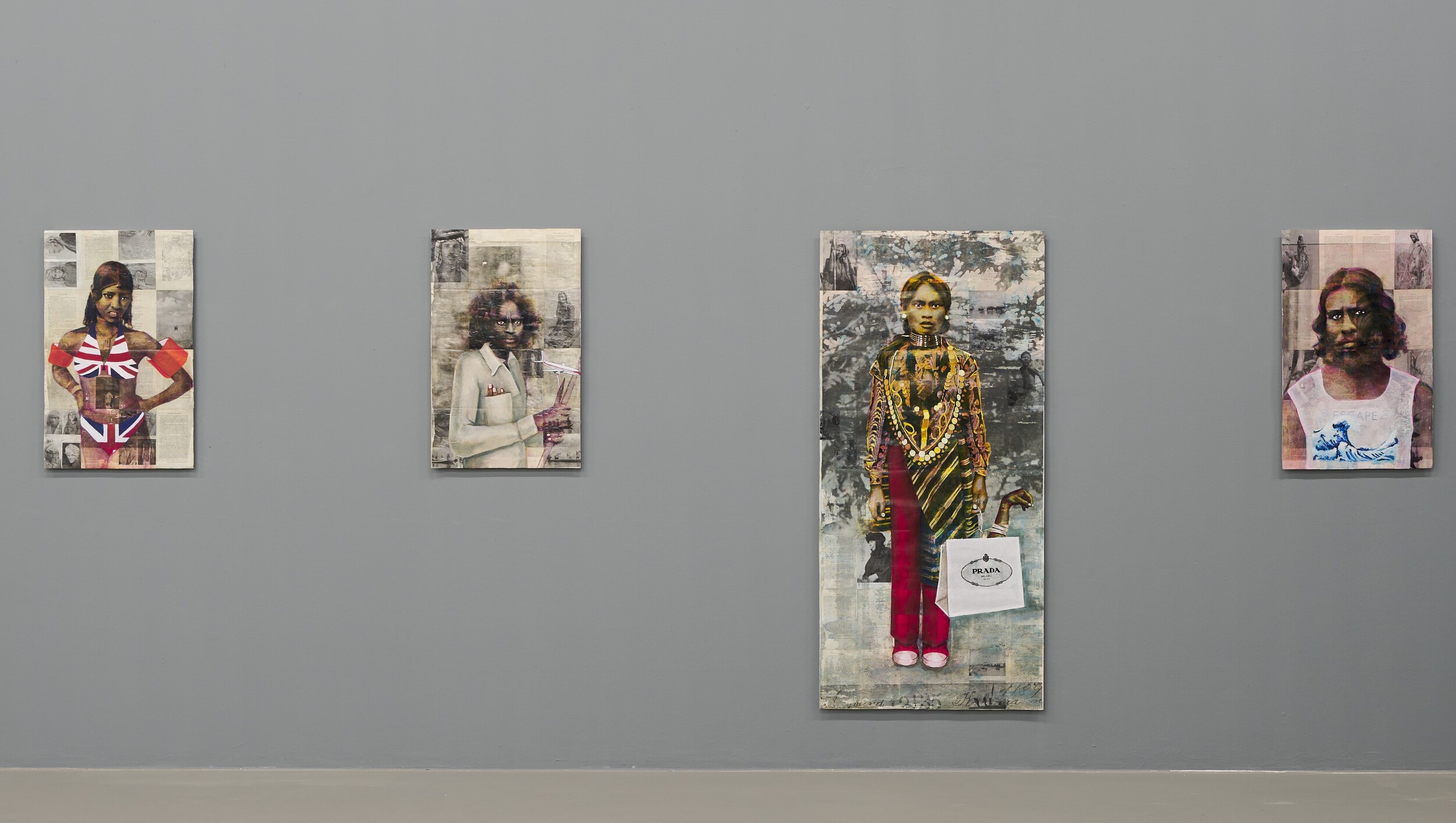 Four vertically oriented portraits hang spaced apart on a gray gallery wall. The works show collage-style depictions of people combined with historical image fragments and various symbolic elements.